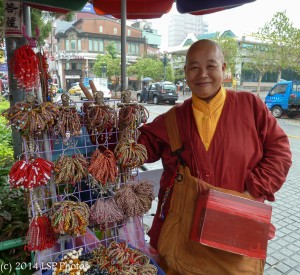 Buddhist monk displaying his prayer bracelets